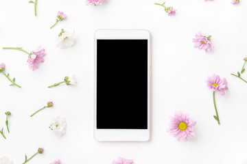 Flatlay with smartphone mock up and floral pattern at white background. Top view