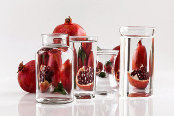 Still life with pomegranate seemed throught glass objects
