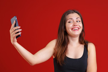 woman using smart phone for texting or chatting, laughing with joy and happy