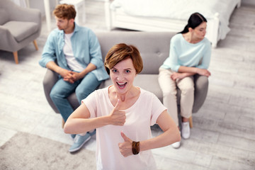 They are divorcing. Joyful aged woman smiling while being happy about the divorce of her son