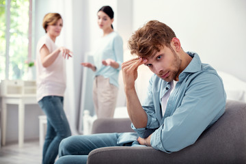 Fototapeta premium I am tired. Nice sad man holding his head while being tired from quarrels