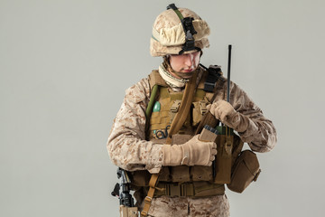 Soldier in camouflage holding rifle