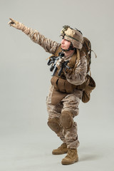 Soldier in camouflage holding rifle