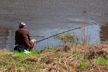 Obraz na płótnie Canvas Angler fishing on the river on a sunny day