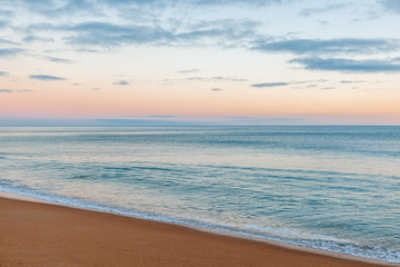 Fototapeta na wymiar Beautiful seascape, sunset by the ocean, with retro toning, sandy beach