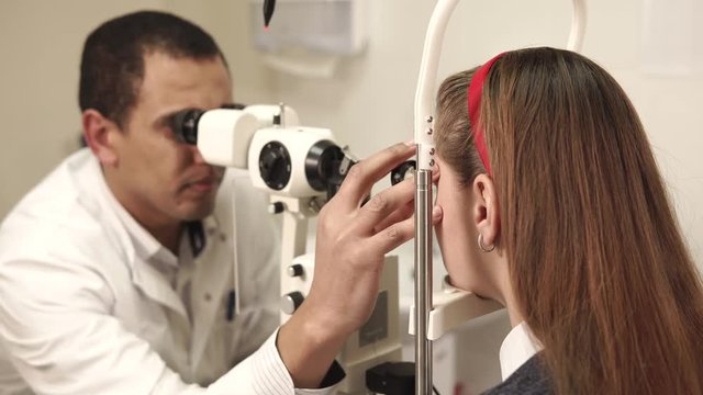 Slit lamp examination. Biomicroscopy of the anterior eye segment. Basic eye examination. Male ophthalmologist.