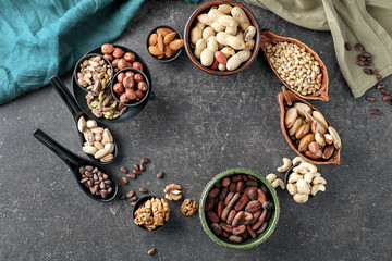 Composition with different nuts on grey background