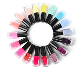 Naklejka premium Frame made of bottles with colorful nail polishes on white background