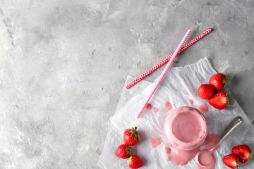 Fototapeta na wymiar Glass jar with tasty strawberry smoothie on light table