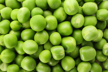 Fresh green peas as background