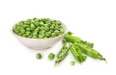 Bowl with green peas on white background