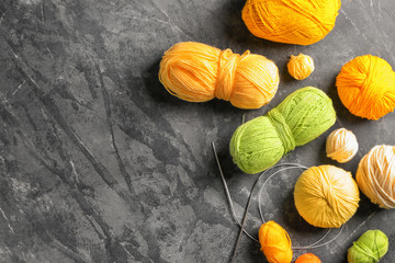 Colorful knitting yarn with needles on table