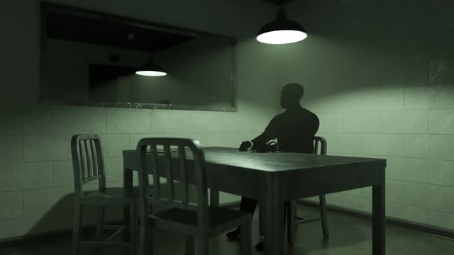 Dark silhouette of a man sitting in the empty interrogation room. Time-lapse