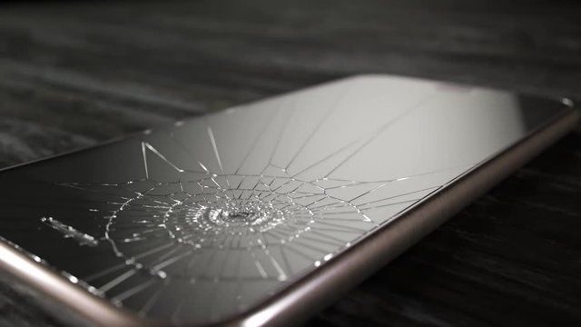 Hammer smashes smartphone in slow motion.  Angry destroying mobile technology.