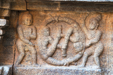 Carvings showing different poses of gymnastic shown by females keeping their head at the centre and legs interwoven. Airavatesvara Temple, Darasuram, Tamil Nadu