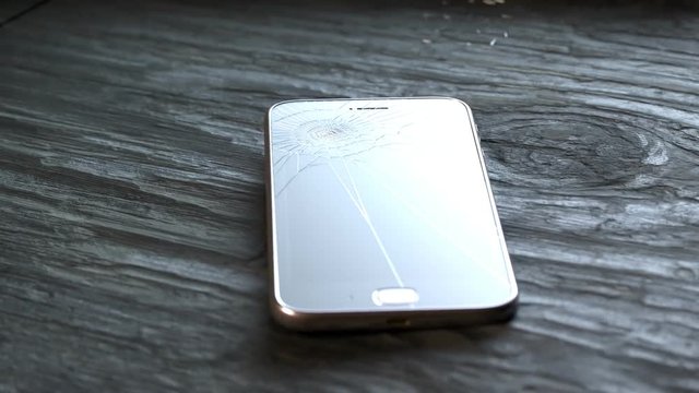 Smartphone crashes onto the wooden floor. Accident insurance coverage.