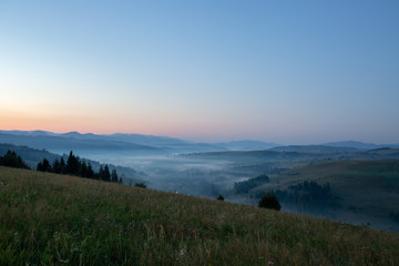 Fototapeta premium Beautiful early morning with fog between mountains