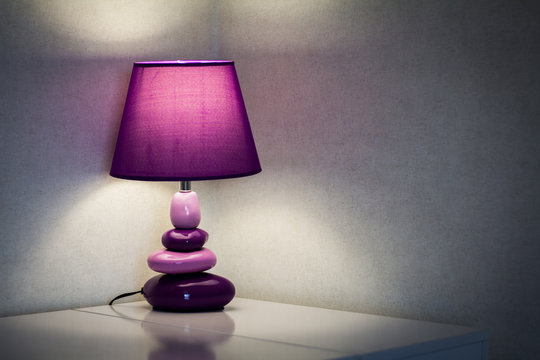 Table lamp illuminates the room at night. Interior.