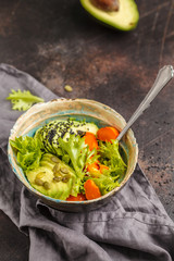 Vegan salad, rainbow bowl with baked sweet potato and avocado. Healthy vegan food concept.