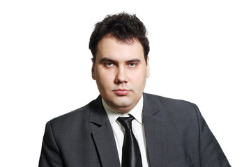 Serious young businessman in suit with tie isolated on white