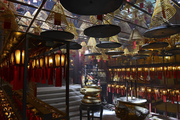 Incense burning with lanterns in dimly lit, traditional Temple in Hong Kong, China