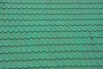 The texture of green dirty roof shingles on the roof