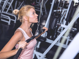Woman working out in gym on machine