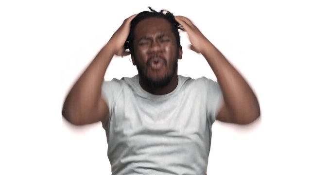 Portrait of irritated dark skinned guy with afro pigtails gesturing hands in frustration and screaming question why to you, isolated over white background. Concept of emotions