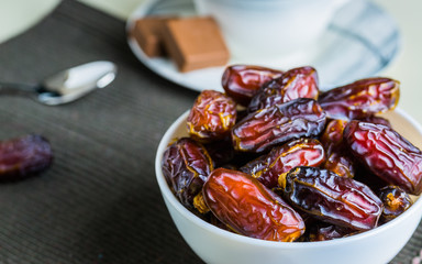 Sweet dried organic dates fruit in small bowl