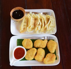 Chicken Nuggets in Plate and Sauce and pot stickers (chinese style gyoza)
