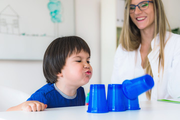 Child psychology, toddler doing tests with plastic cups