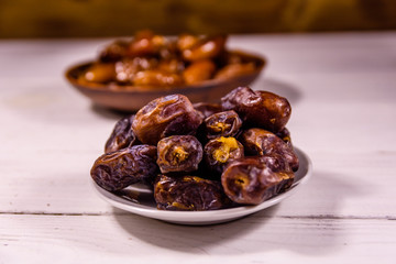 Date fruits on the white wooden table