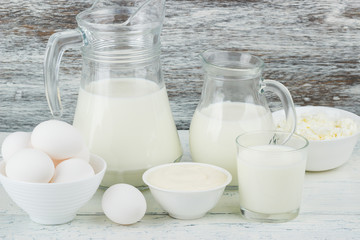 Different dairy products on the wooden background
