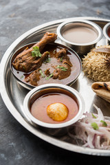 Kolhapuri chicken Thali is a popular Indian/asian food platter consists of poultry meat, egg curry with chapati ,rice, salad and sweet Gulab Jamun