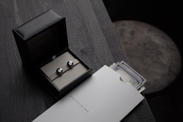 Jewelry and an envelope with money on the table