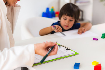 Child psychology, little boy talking to psychologist