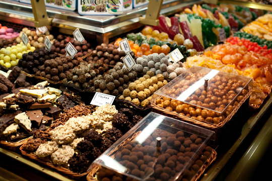 Famous sweet candy market .Confectionery at Boqueria market place in Barcelona, Spain. Assorted chocolate candy shop.