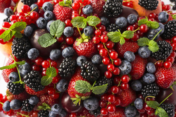 Ripe blackberries, blackberries, strawberries, red currants, peaches and plums. Mix berries and fruits. Top view. Background berries. Various fresh summer fruits.