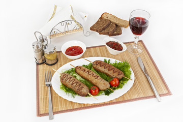 Lula kebab with tomatoes and cucumbers. Serve with black or white bread and a glass of red wine.