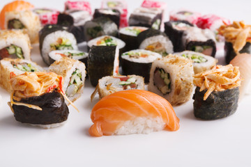 Set of sushi, maki and rolls on white