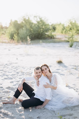 beautiful young couple hugging on beach