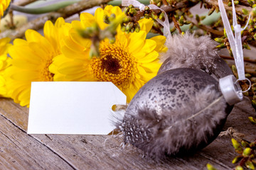Flowers with a card and easter decoration
