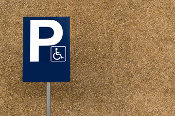 blank handicapped parking street sign on post with rocky background and lots of copy space