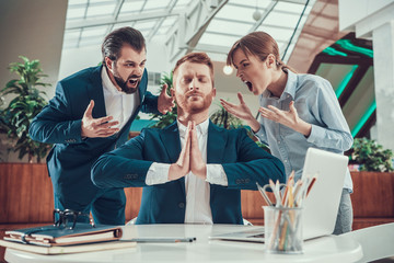 People shout at meditating worker in office. - obrazy, fototapety, plakaty