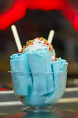 Roll ice cream is made by hand on the freezer. Sweet dessert made from natural berries and ingredients.
