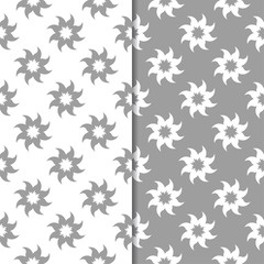 White and gray floral ornamental designs. Set of seamless patterns