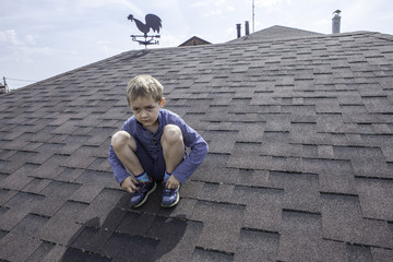 Sad boy on a roof. © Irina