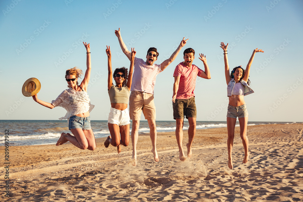 Wall mural Group of excited young friends