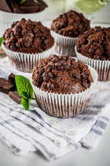 Home baked mint and chocolate muffins with mint tea, white marble background copy space