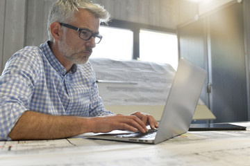 Industrial designer working on laptop in office